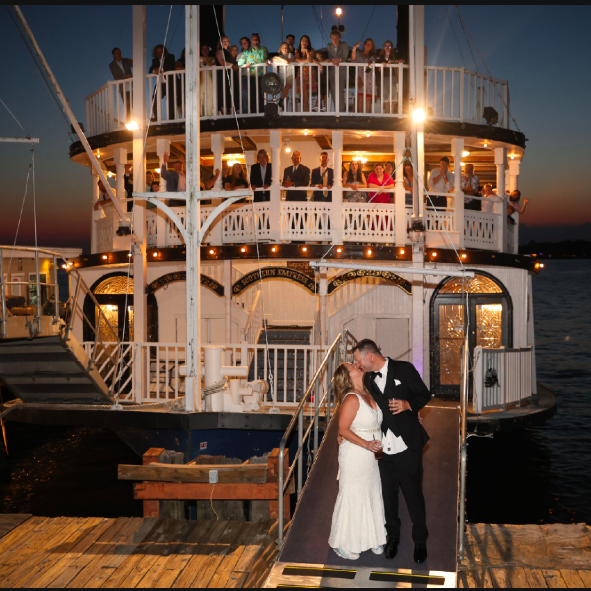 a person sitting on a dock next to a body of water